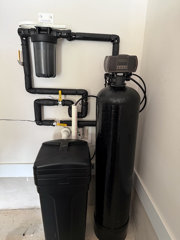 Single treatment tank, prefilter, and brine tank in a corner